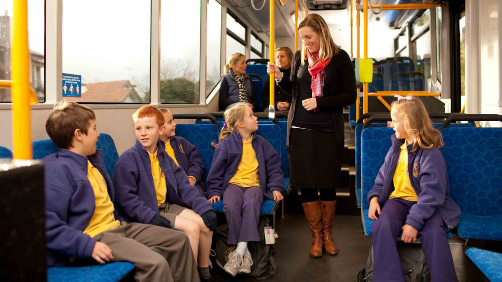 Teacher and school students on bus