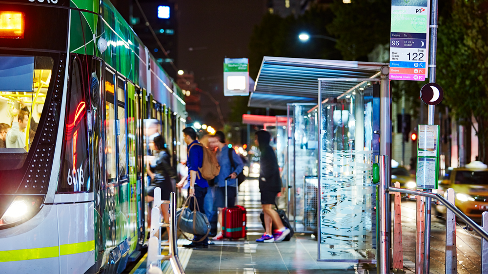 Passengers boarding tram at stop